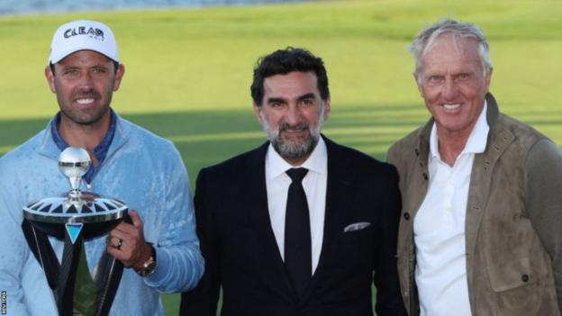 Charl Schwartzel with Yasir Al-Rumayyan and Greg Norman after winning the inaugural LIV Golf event in June 2022