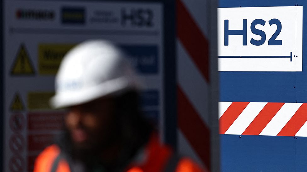 Hs2 sign with construction worker in foreground