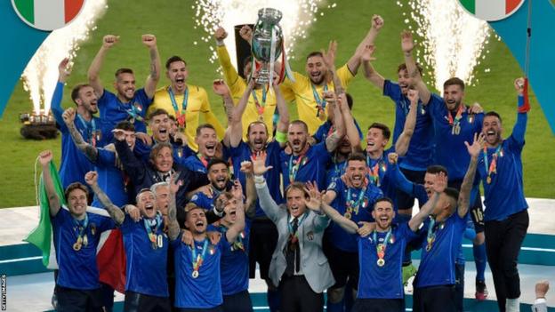 Italy's players lift the Henri Delaunay Trophy after they beat England on penalties at Euro 2024